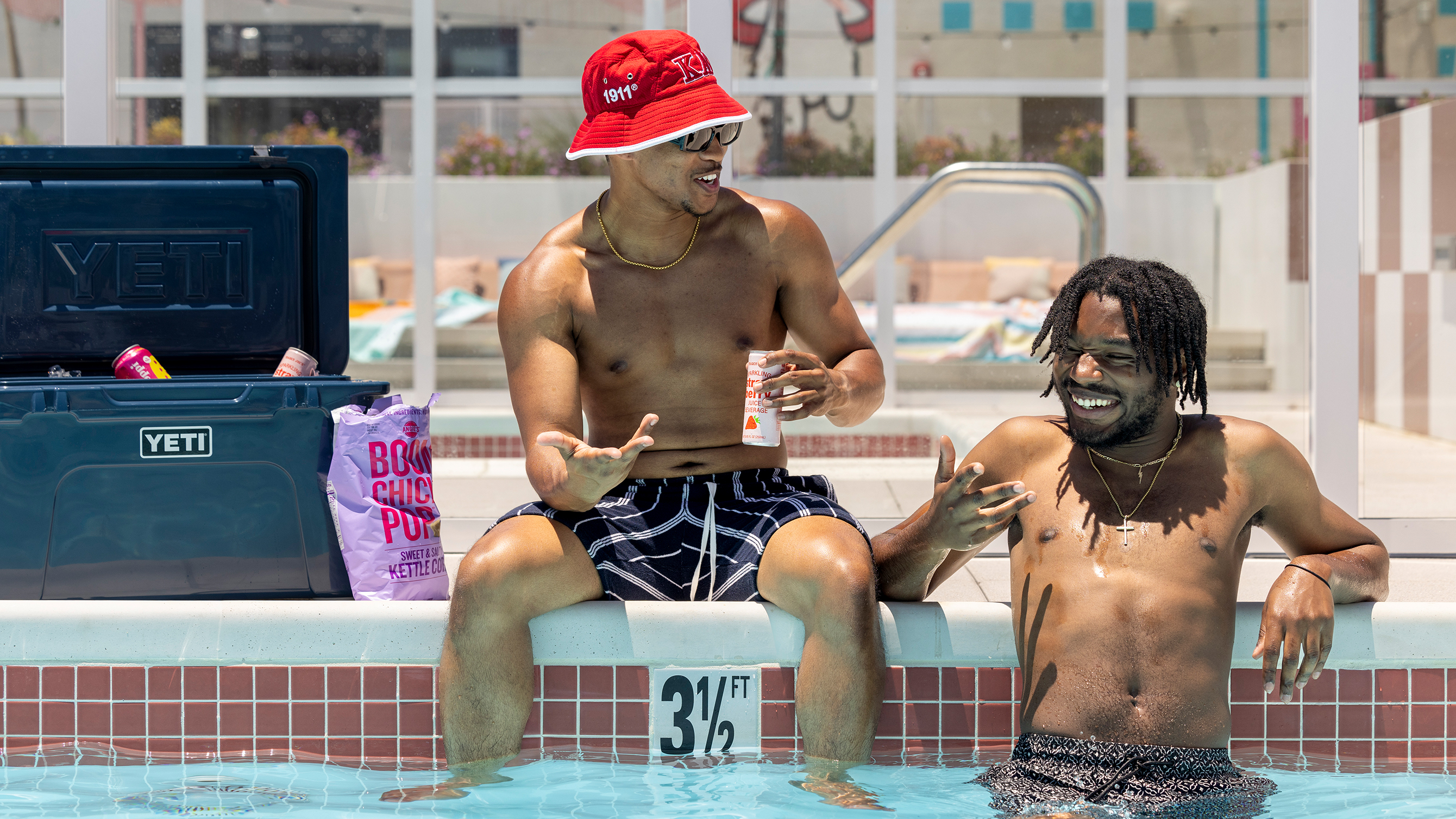 Two friends smiling in a swimming pool